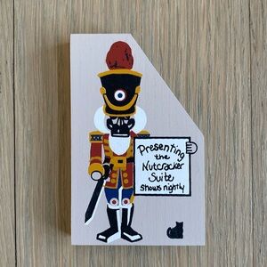 Nutcracker with Nutcracker Suite Sign - The Cat's Meow